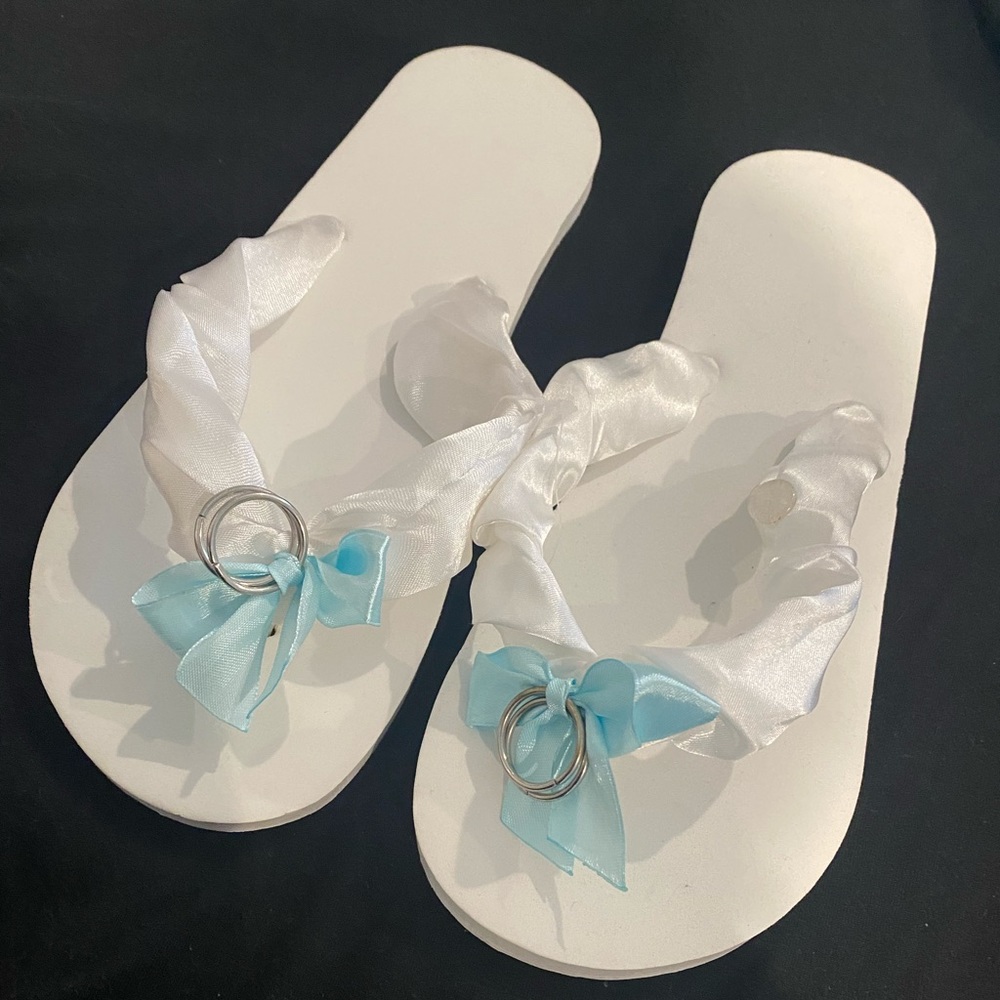 Bride “just married” sand imprinting flip flops
